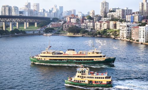 Boats in river with buildings in background