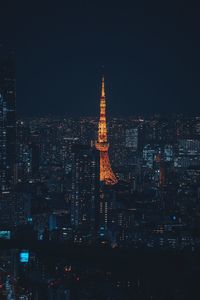 Illuminated cityscape against sky at night