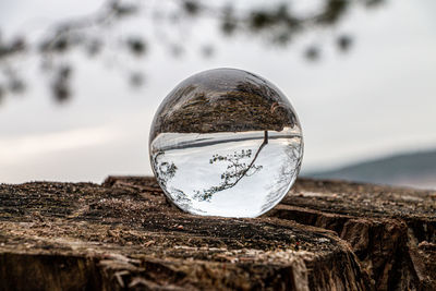 Close-up of crystal ball on beach