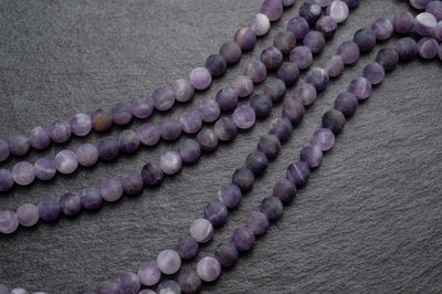 High angle view of purple petals on white background