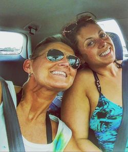 Portrait of smiling young woman in car