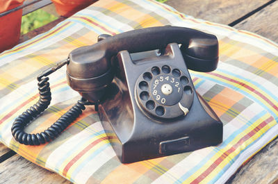 High angle view of telephone on wooden table