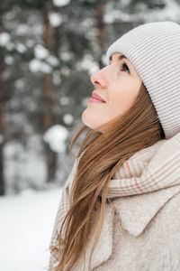 Portrait of a girl in warm clothes in a winter forest. high quality photo