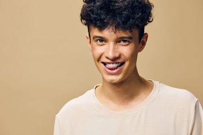 Portrait of young man against pink background