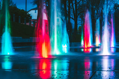 Digital composite image of illuminated fountain at night