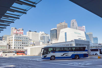 City street and modern buildings against clear sky