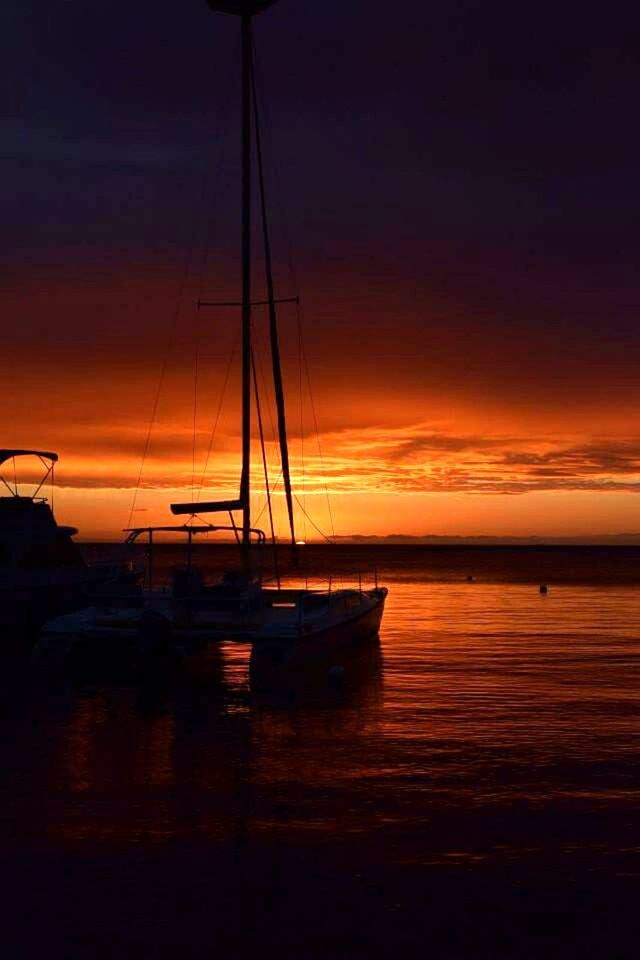 SAILBOATS IN SEA DURING SUNSET