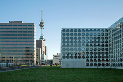 Modern buildings in city against clear sky