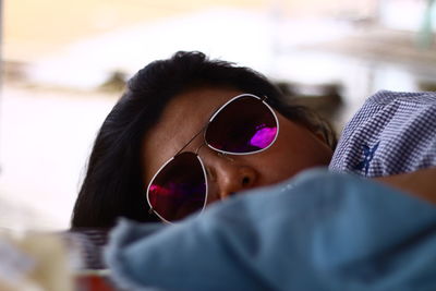 Close-up portrait of woman wearing sunglasses