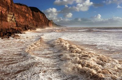 Scenic view of sea against cloudy sky