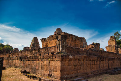 Low angle view of old ruins against blue sky