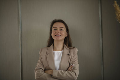 Happy businesswoman in office. stylish beautiful manager smiling, green wall, financial projects