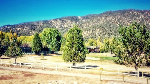 Scenic view of mountains against clear blue sky