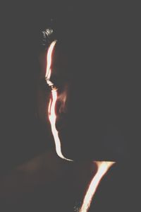 Close-up of young woman in darkroom