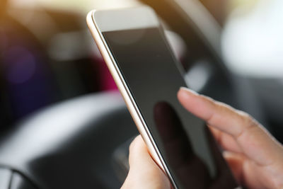 Midsection of man using mobile phone