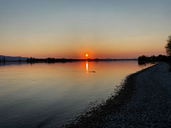 Scenic view of lake against sky during sunset