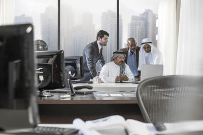 Western businessmen having meeting in middle eastern office