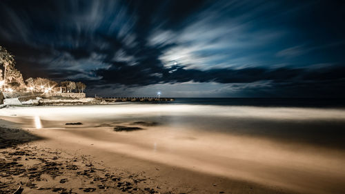 Scenic view of beach against sky at night