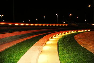 Illuminated light trails against sky at night