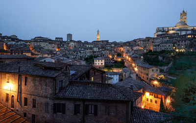 High angle view of illuminated buildings in city at night