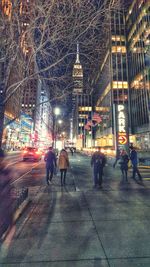 Woman standing in illuminated city
