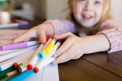 Close-up of girl drawing on table