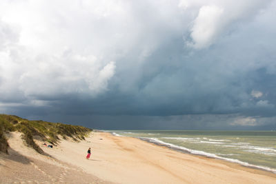 Scenic view of empty beach against sky