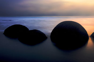 Scenic view of sea against sky at sunset