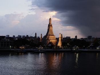 View of wat arun against sky at sunset