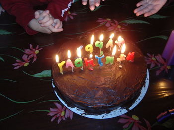 Midsection of woman with multi colored cake