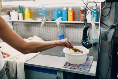 Cropped hands of woman preparing coffee