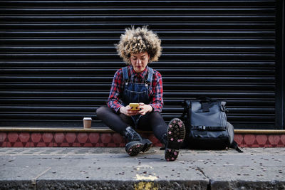 Portrait of teenage girl sitting outdoors