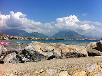 Scenic view of sea and mountains against sky