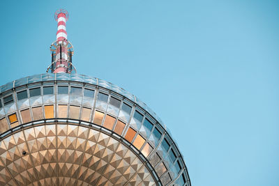 Low angle view of modern building against blue sky
