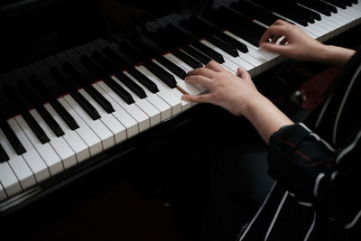 Midsection of woman playing piano