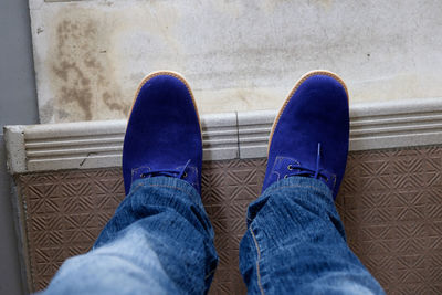 Low section of woman standing on tiled floor