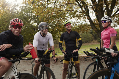 Smiling cyclists talking while resting