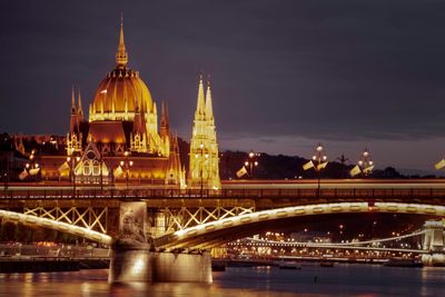 Illuminated bridge and the parlaiment  building against sky in budapest