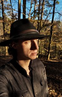 Portrait of man looking away in forest