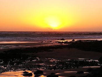 View of beach at sunset