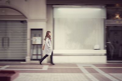 Woman walking in corridor of building