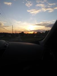 Road in city against sky during sunset