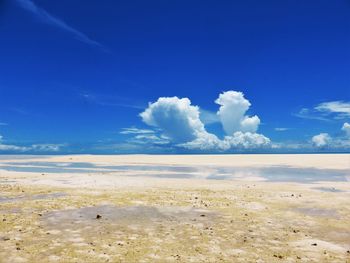 Scenic view of landscape against blue sky