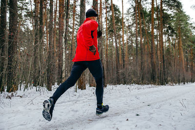 Full length of man skiing on snow covered landscape