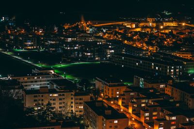 High angle view of city lit up at night