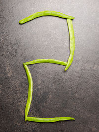 Directly above shot of green chili pepper over white background