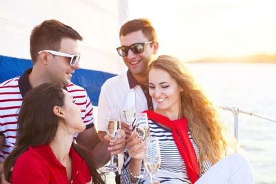 Happy young woman drinking glass with water