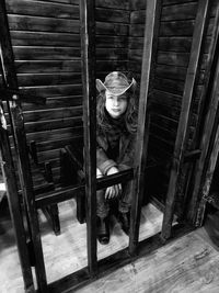 Portrait of boy sitting on wooden floor