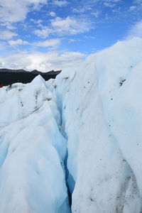 Snow covered landscape against sky