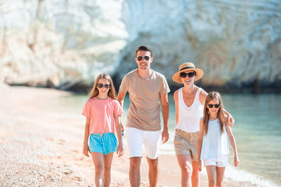 Full length of girl wearing sunglasses on shore